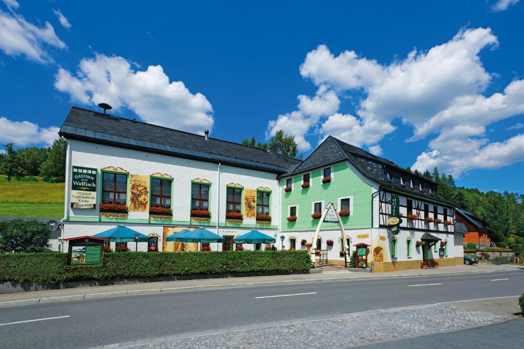 un grand bâtiment sur le côté d'une rue dans l'établissement Hotel Gasthof zum Walfisch, à Klingenthal