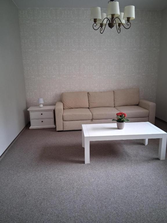 a living room with a couch and a coffee table at Šiluvos Svaja in Šiluva