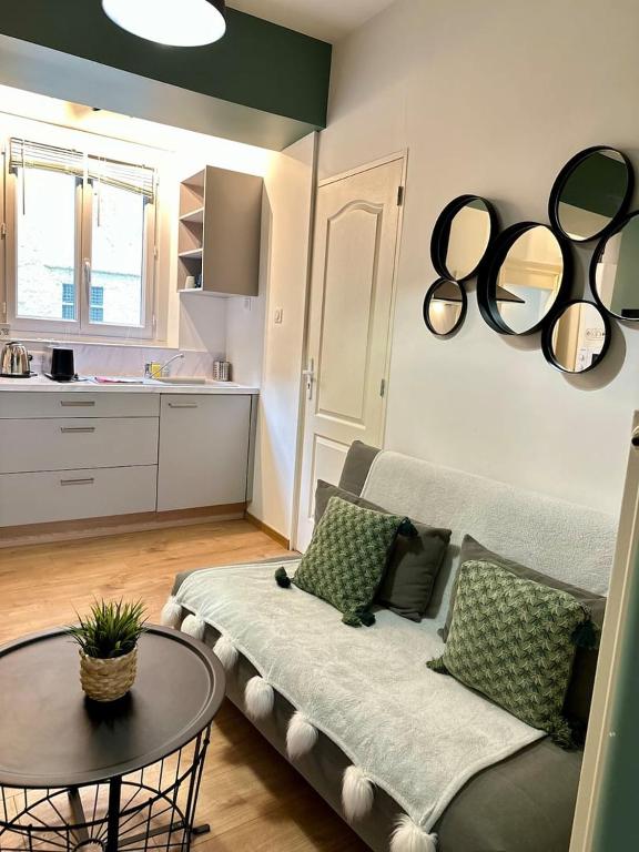 a living room with a couch and a table at Le Patio Spa in Chartres