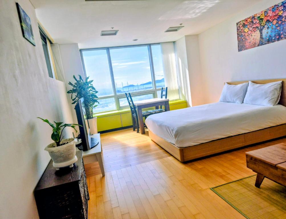 a bedroom with a bed and a table and a window at Cozy - Experience Home like Comfort Studio in Incheon