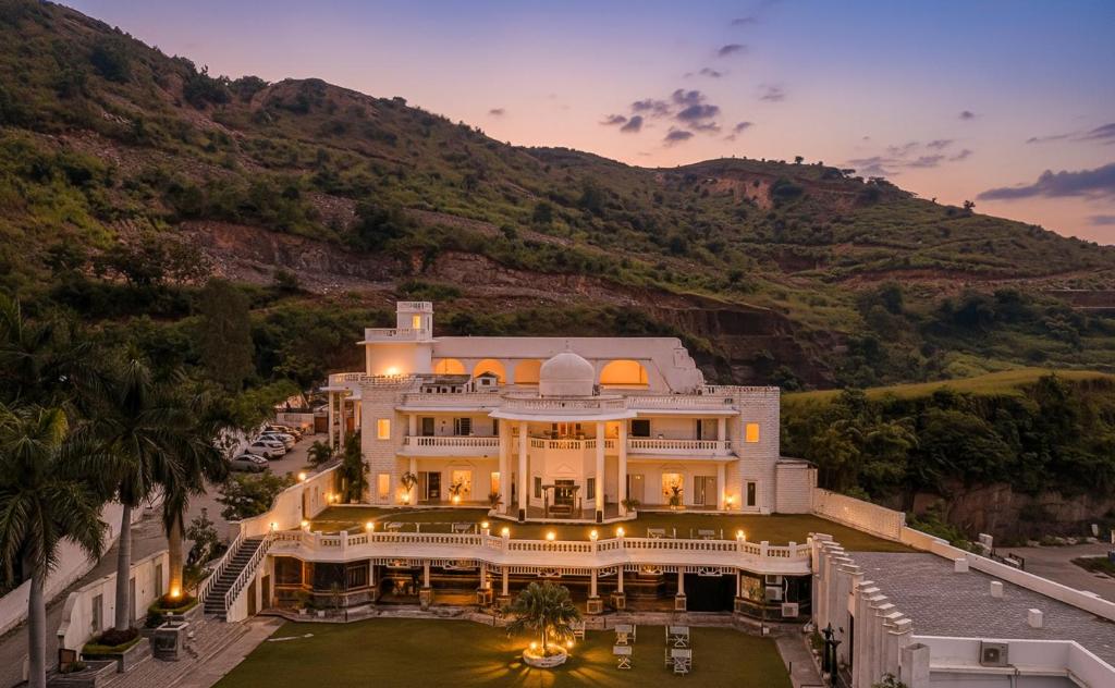an aerial view of a mansion with a mountain at Victoria Mansion - A Signature Collection by HST Hotels, Pure Vegetarian in Udaipur