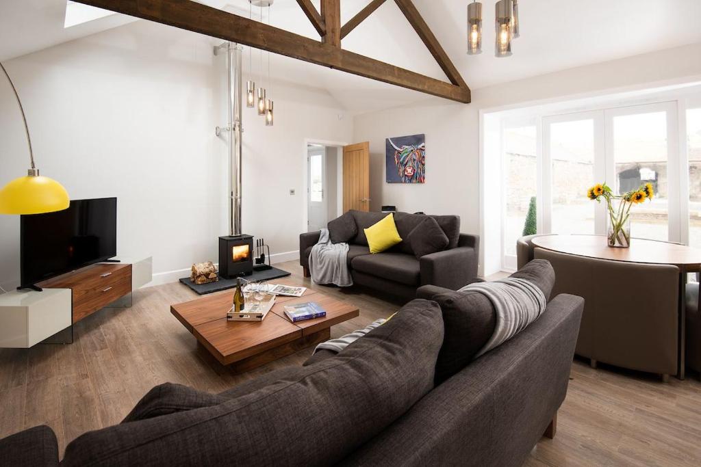a living room with a couch and a table at The Stables at West Lyham in Chatton