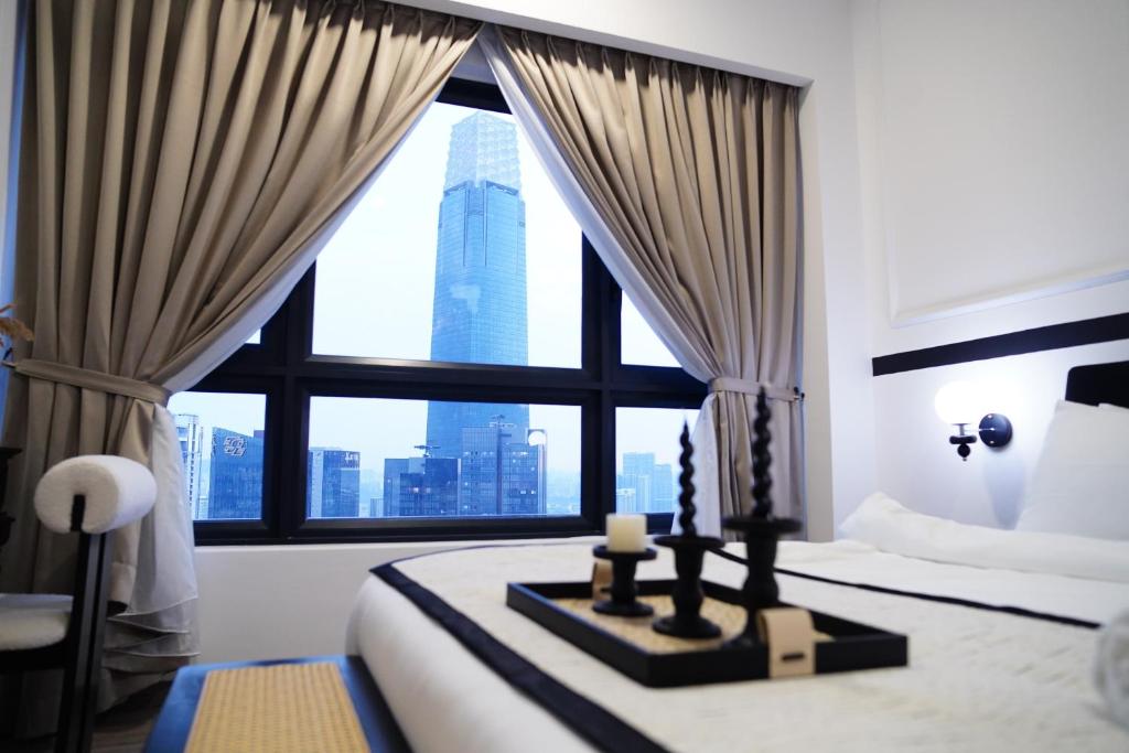 クアラルンプールにあるAgile Residence Bukit Bintang by Skyline Homesの大きな窓のあるベッドのある寝室