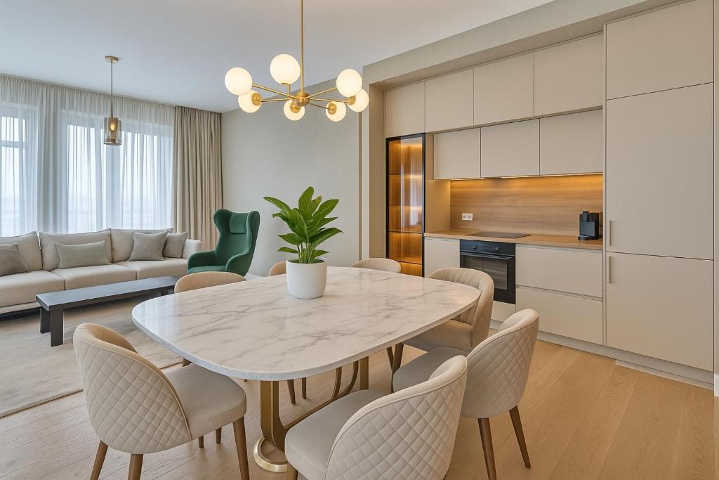 a kitchen and dining room with a white table and chairs at Belgrade Waterfront Nostra Casa in Sajmište