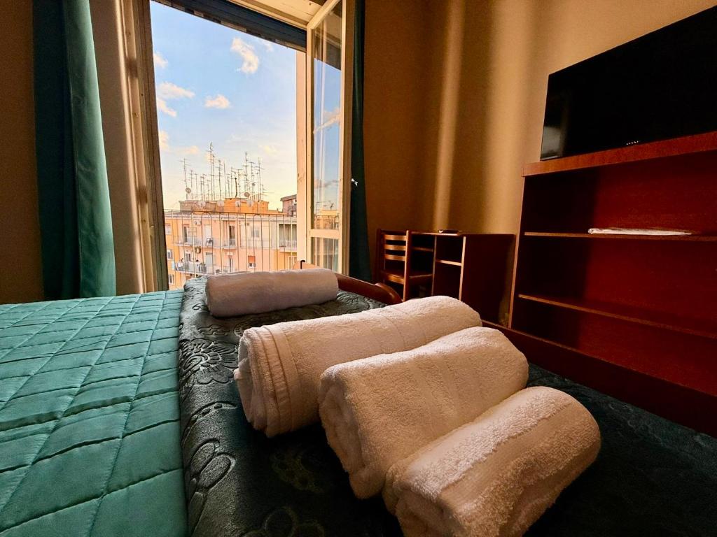 a bedroom with a bed and a large window at VIMAVÌ Rooms & Apartment in Catania