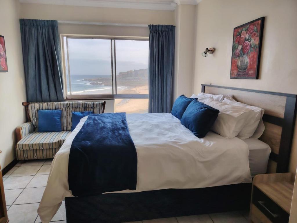 a bedroom with a bed and a couch and a window at Santana Resort 401 in Margate