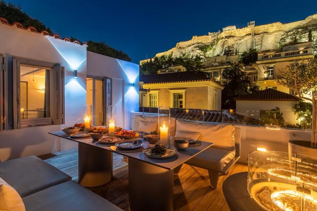 a patio with a table with candles on it at Plaka Villa with Epic Acropolis Views in Athens