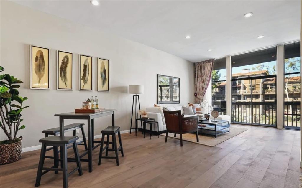 a living room with a table and chairs at Waterfront Three-Bedroom Condo with Great Views in Naples