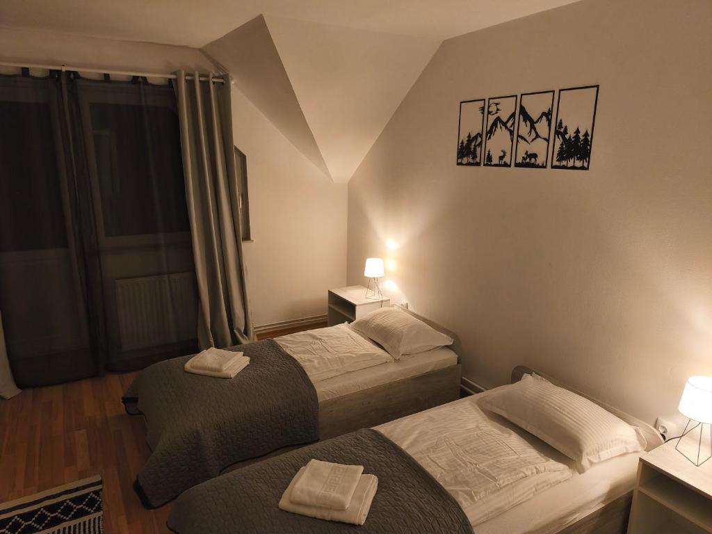 a hotel room with two beds and a window at The Other House in Miercurea-Ciuc