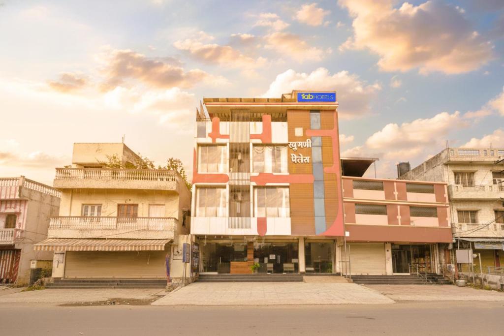 a building with a sign on the top of it at FabHotel Raghumani Palace - Nr Mahakal Mandir in Ujjain