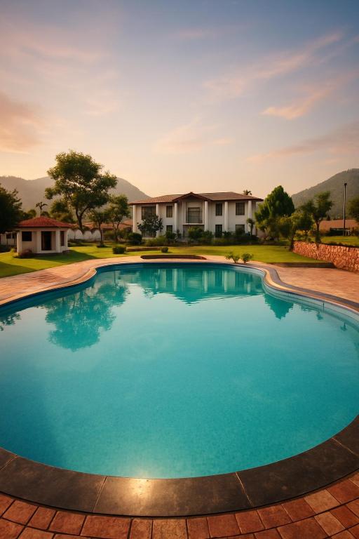 a large blue swimming pool in front of a house at Virat Resorts, Sariska Rajasthan in Bairāt
