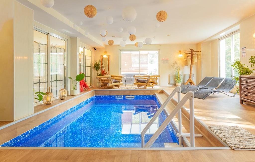 a house with a swimming pool in a living room at La Maison Mori in Vienne