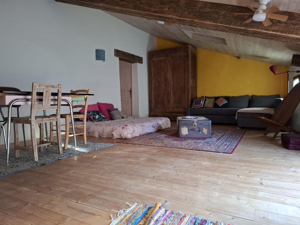 a living room with a couch and a table at Gîte dans La circulade - Le Pouget in Le Pouget