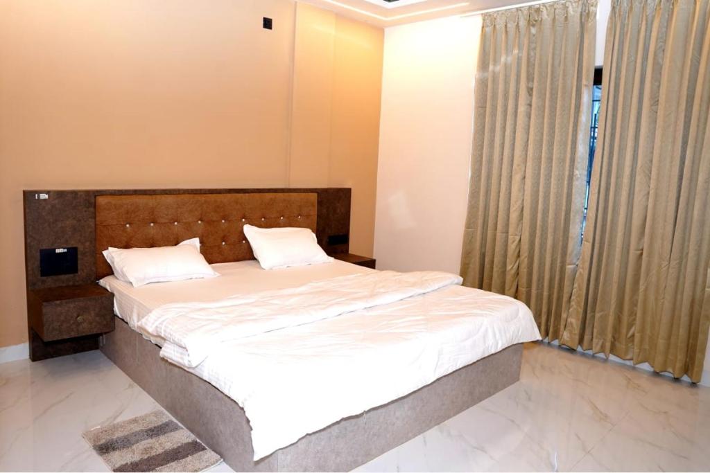 a bedroom with a bed and a large window at Shakthi Homestay in Sringeri