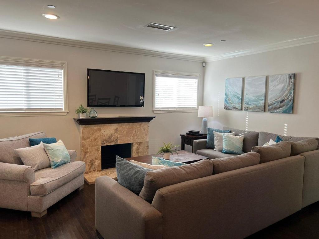 a living room with two couches and a fireplace at Destination #12 in Anaheim