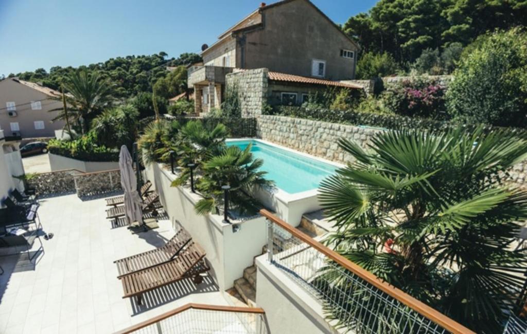 a view of a house with a swimming pool at Palm Tree Apartments in Dubrovnik