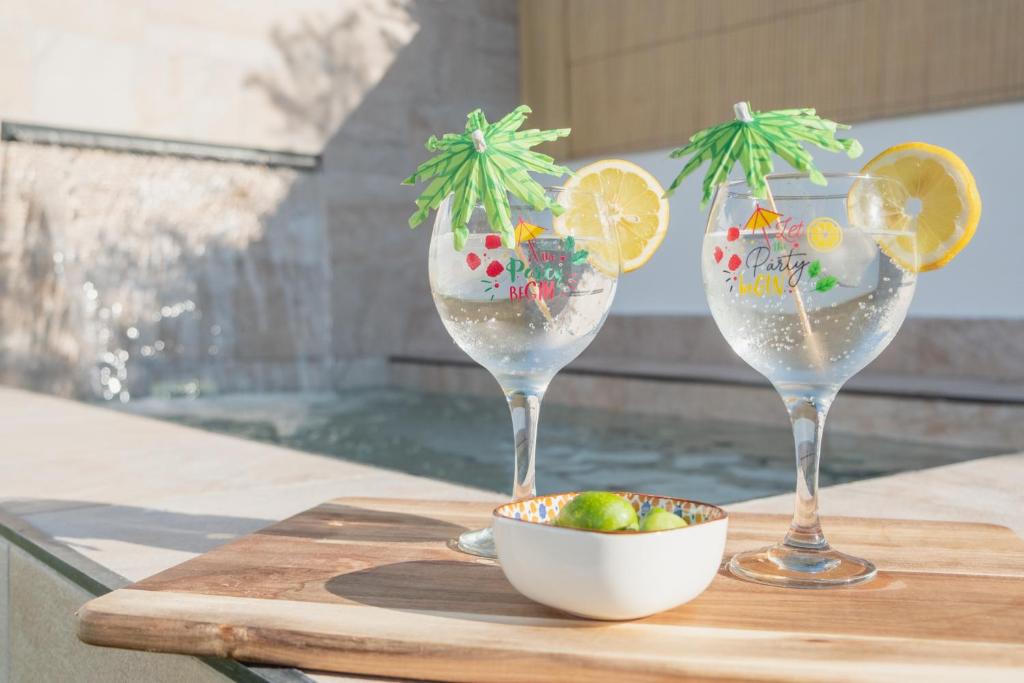 three wine glasses with fruit in a bowl on a table at Mirador de la Peña in Arcos de la Frontera