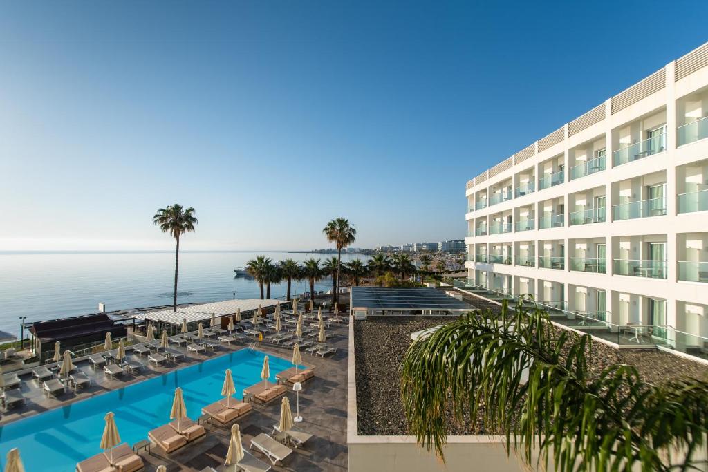 a view of a hotel with chairs and a swimming pool at Evalena Beach Hotel in Protaras