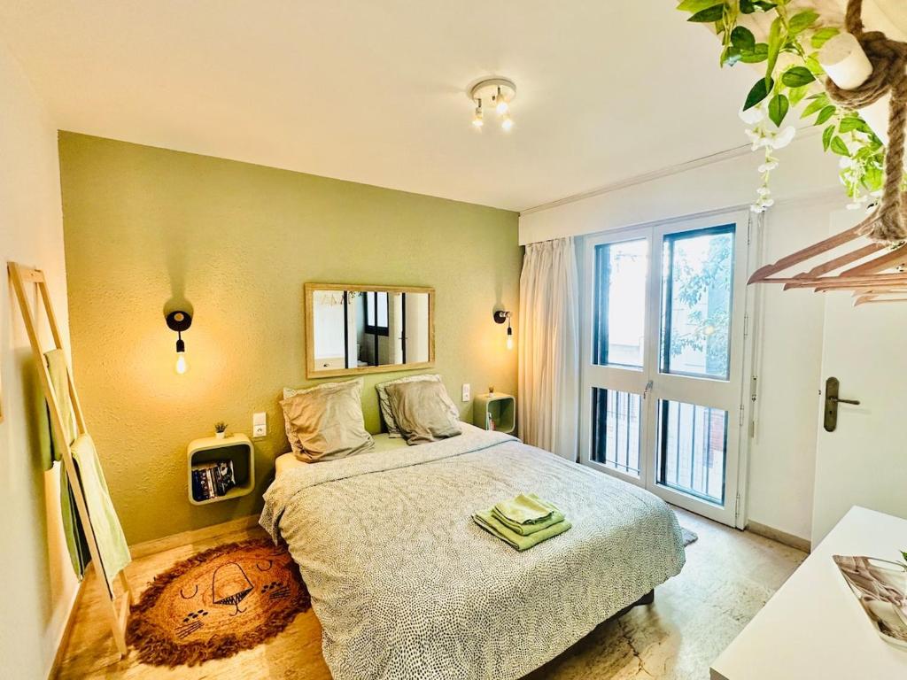 a bedroom with a bed and a large window at LE VERT accommodation for 3 guests near train station in Perpignan