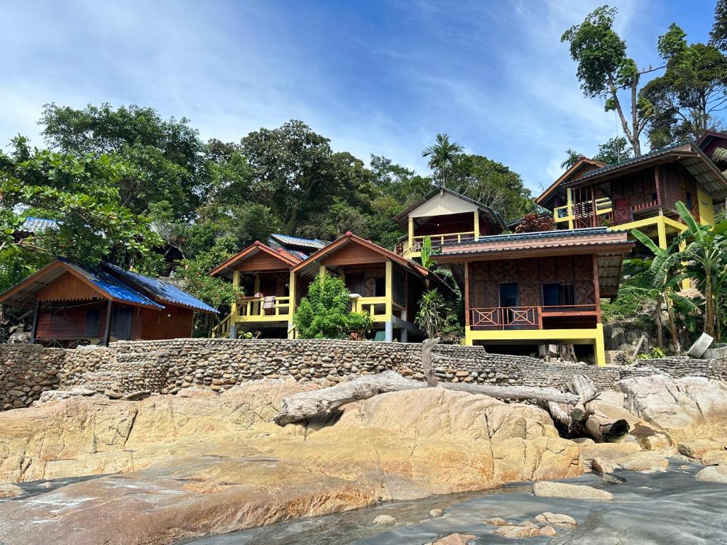 a group of houses on a hill near the water at Mama's Bungalows Koh Chang Ranong in Koh Chang Ranong