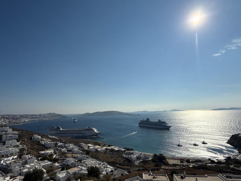 two boats docked in the water in a harbor at Aloft Suites Mykonos in Agios Stefanos