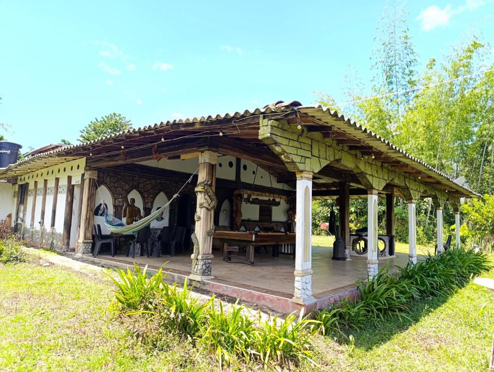 a gazebo with a hammock in a yard at Grande y hermosa casa de tapia in San Carlos
