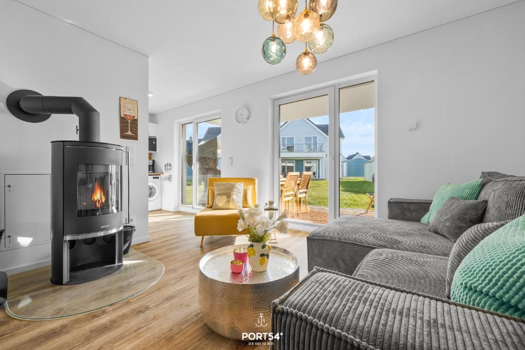 a living room with a couch and a fireplace at Ferienwohnung Matrosenloft Olpenitz in Olpenitzdorf