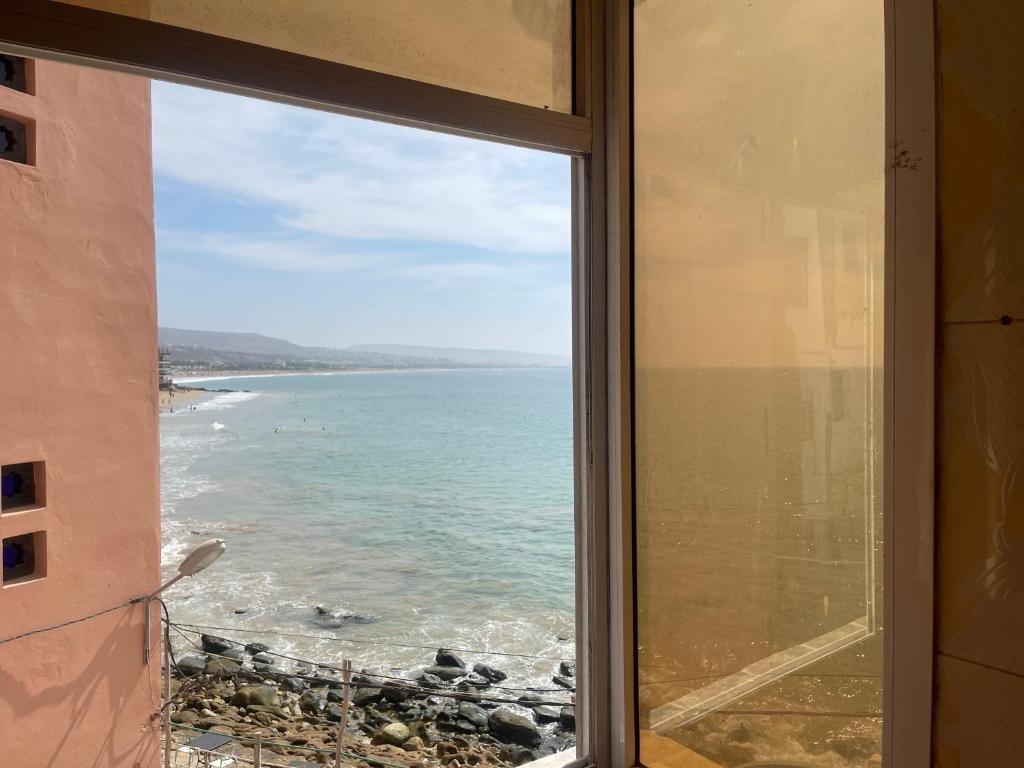 a view of the ocean from a window at Robscal Apartments by Surf Times in Taghazout
