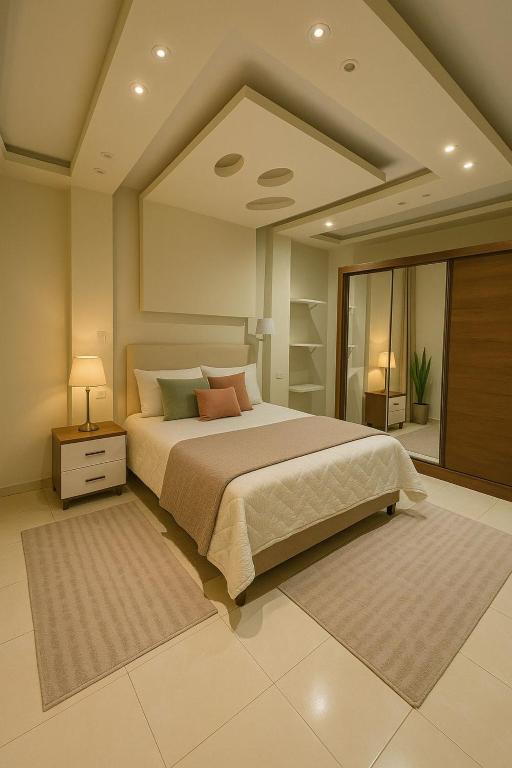 a bedroom with a large bed and a large mirror at Madinty Stylish Stay in B6 in Madinaty
