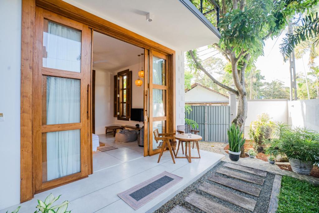 an open door of a house with a patio at Madiha Venus in Matara