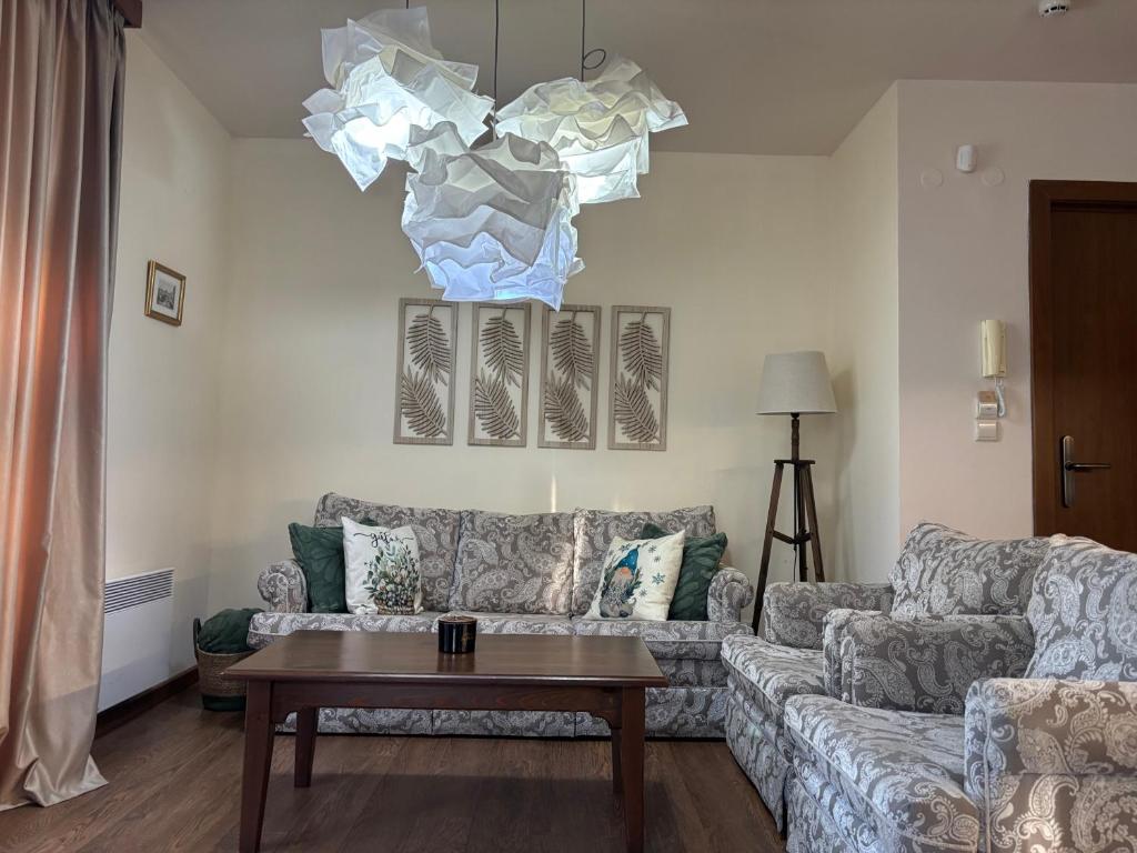 a living room with a couch and a table at Emily Pirin Golf in Razlog
