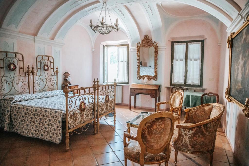 a bedroom with a bed and a table and chairs at Cascina Bringin in Mondovì