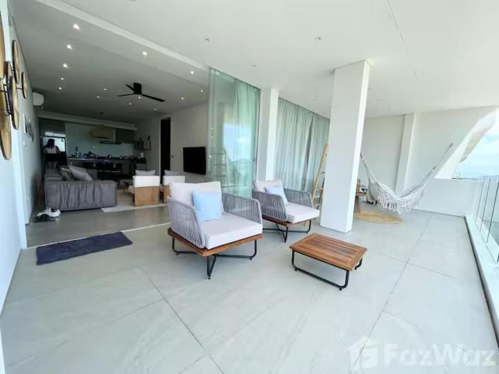 a living room with two chairs and a table at Golden Lotus Villas in Amphoe Koh Samui