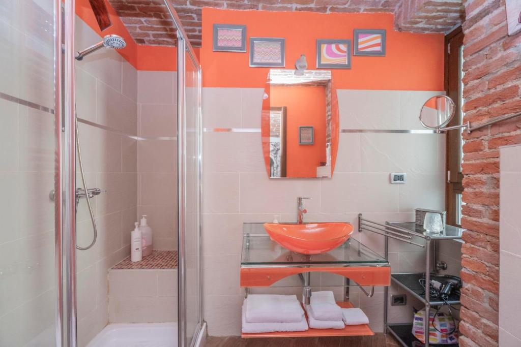 a bathroom with a glass sink and a shower at Ladyemma in Turin