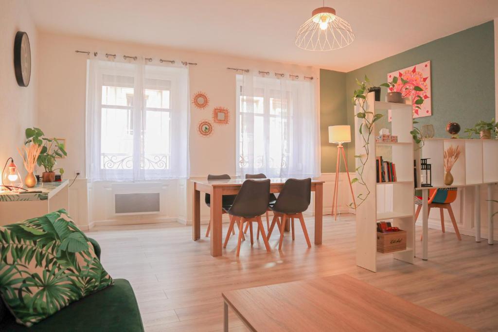 a living room with a dining room table and chairs at Urban Green Spirit - Centre historique, familial in Mulhouse