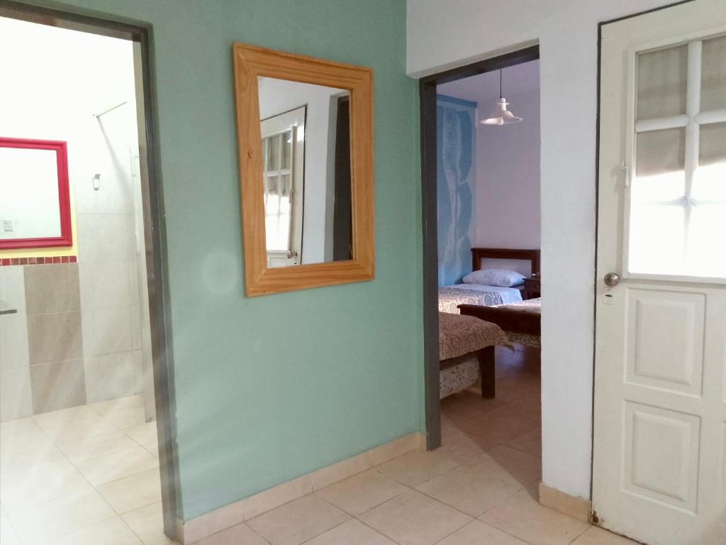 a bathroom with a mirror and a walk in shower at Apart Hotel Bell in San Fernando del Valle de Catamarca