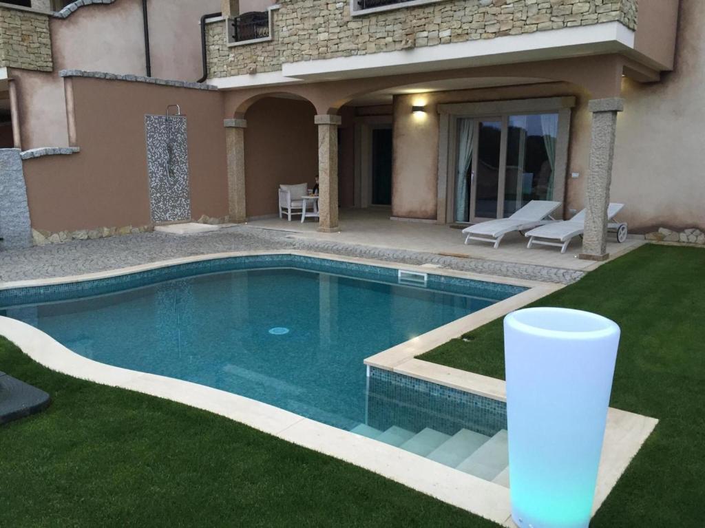 a swimming pool in the yard of a house at Villa Bellavista Chia in Chia