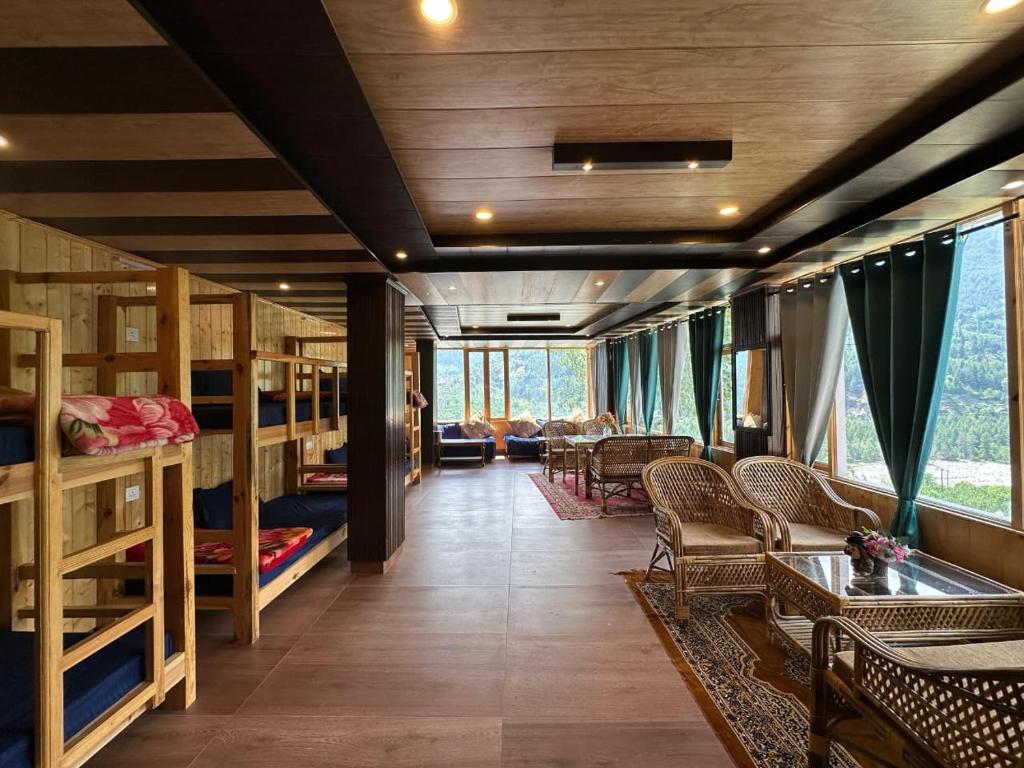 a train car with bunk beds and a living room at River Bed in Vashisht