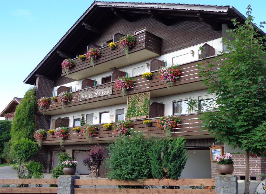 a building with flower boxes on the side of it at Gasthof - Pension Schamberger in Neukirchen beim Heiligen Blut