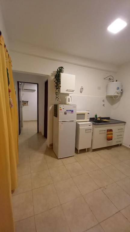 a kitchen with a refrigerator and a counter top at Norita Alquiler Temporal - Departamento in La Rioja