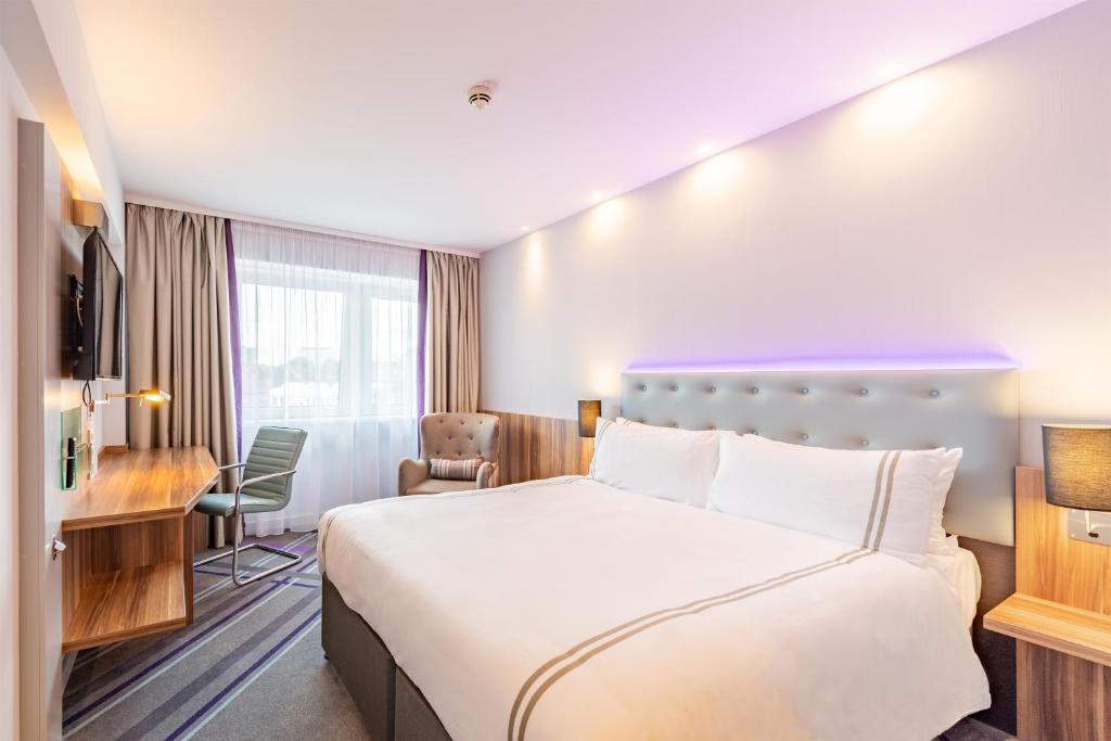 a hotel room with a bed and a desk at Premier Inn Hamburg City Alster in Hamburg