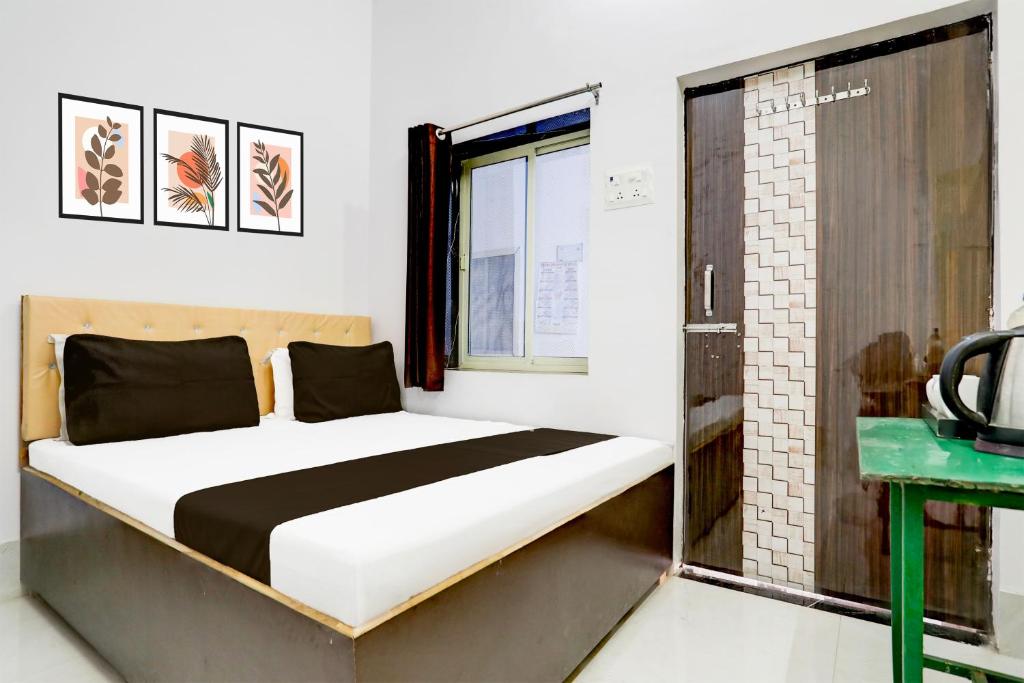 a bed in a room with a window at Indian Hotel in Bareilly
