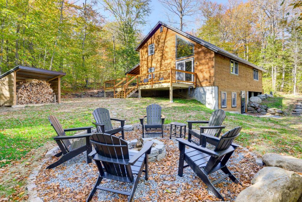 eine Gruppe von Stühlen vor einem Blockhaus in der Unterkunft Hike, Ski and Relax Renovated Retreat in Wilmington in Wilmington