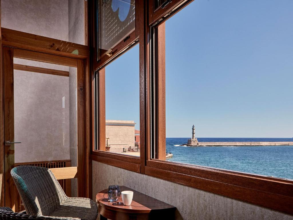 a room with a window with a view of the ocean at Domus Renier Boutique Hotel - Historic Hotels Worldwide in Chania Town