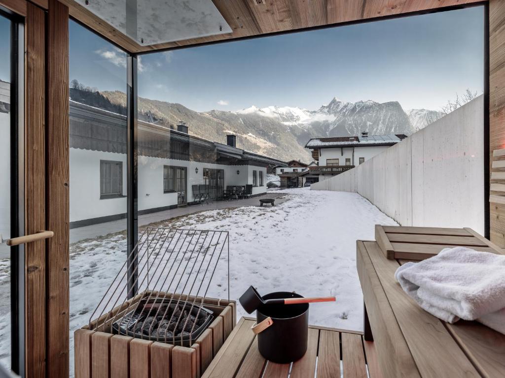 a room with a large window with snow on the ground at Chalet Pirchhof inklusive Sauna in Sautens