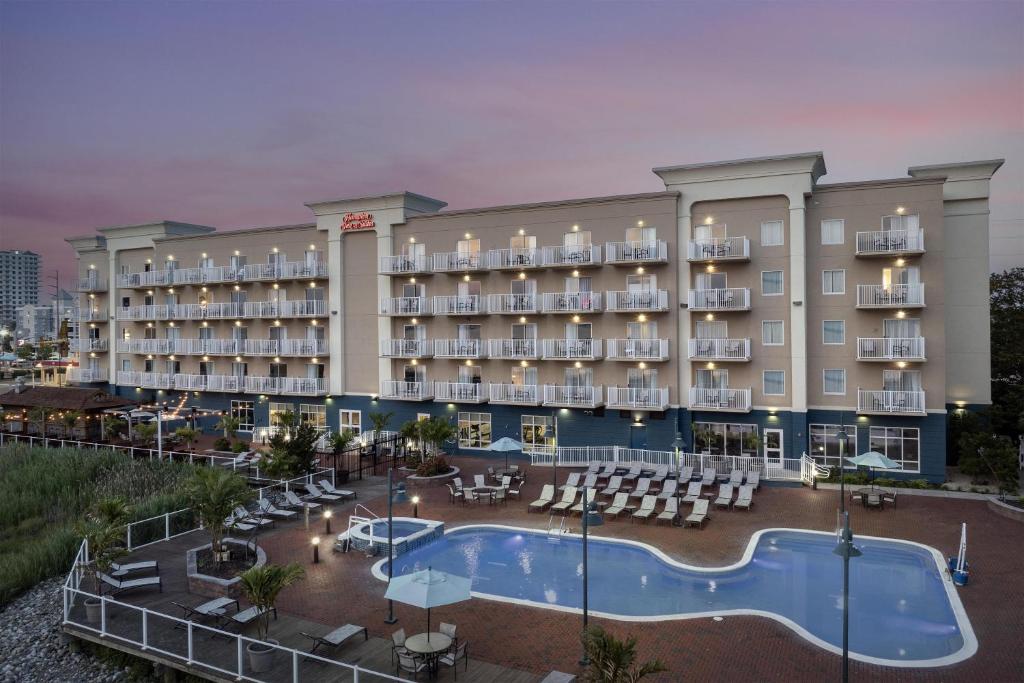 an exterior view of a hotel with a swimming pool at Hampton Inn & Suites Ocean City Bayfront-Convention Center in Ocean City