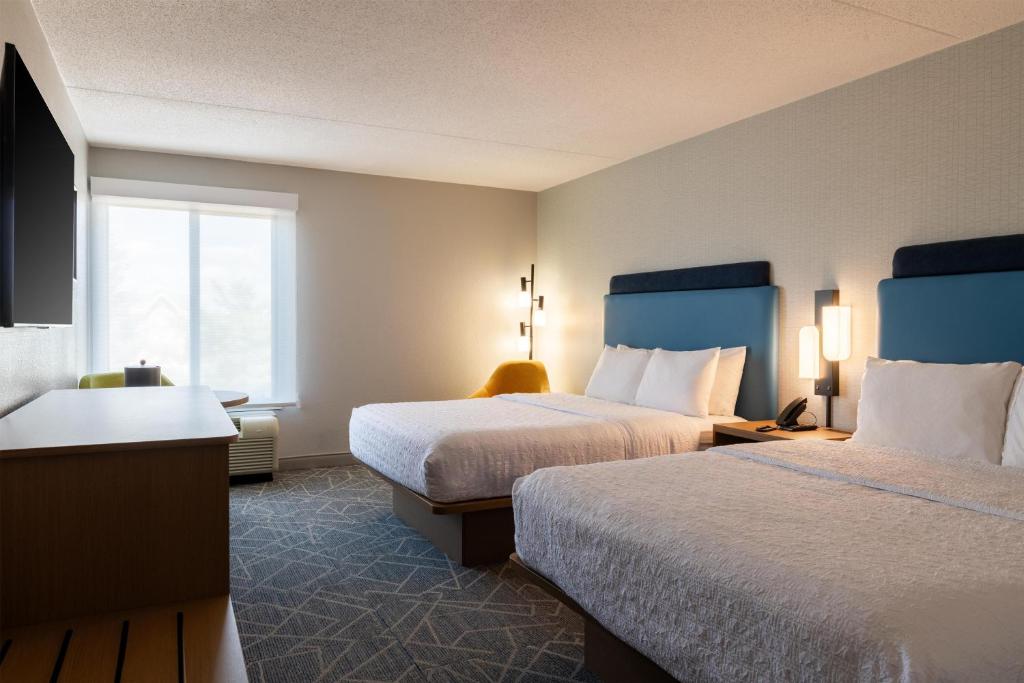 a hotel room with two beds and a window at Hampton Inn Portsmouth Central in Portsmouth