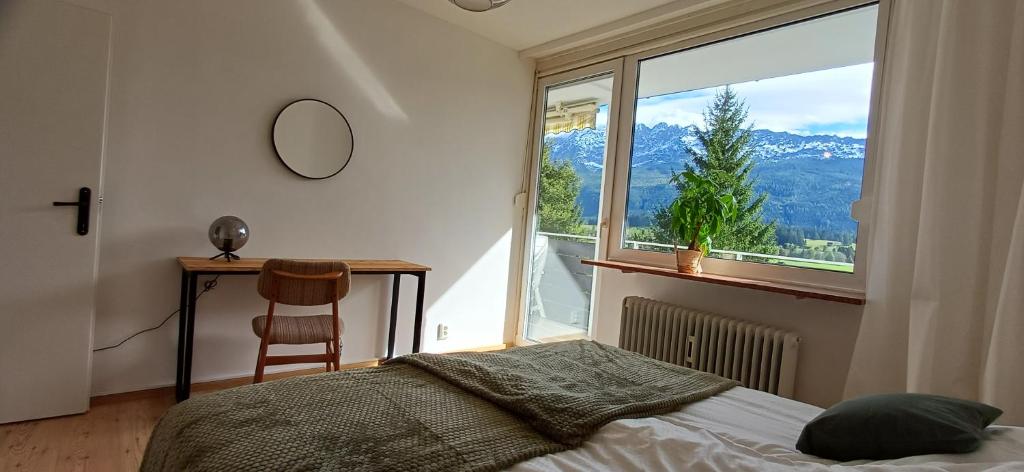 a bedroom with a bed and a large window at Ferienwohnung Naturblick in Bad Mitterndorf