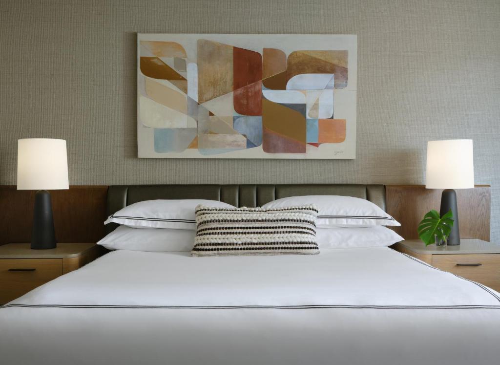 a bedroom with a white bed with two lamps at Kimpton Hotel Palomar Phoenix Cityscape by IHG in Phoenix