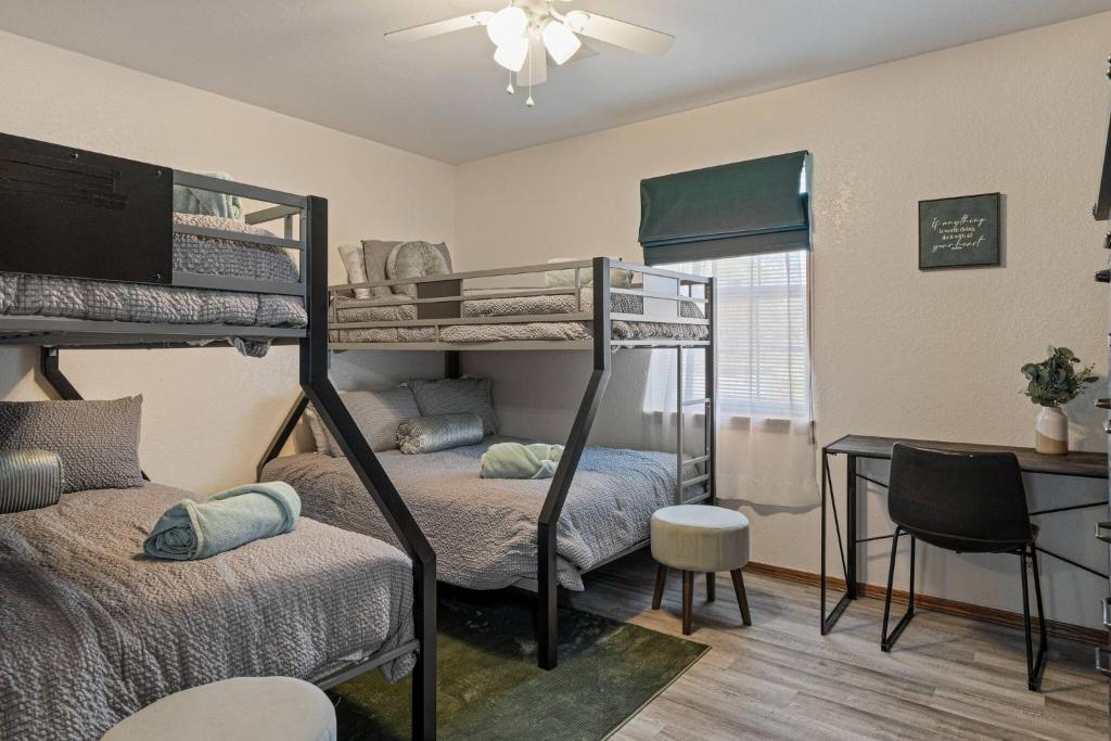 a bedroom with two bunk beds and a desk at Just Like Home #15:Moore 5bd,4ba w/pool & hot tub in Moore